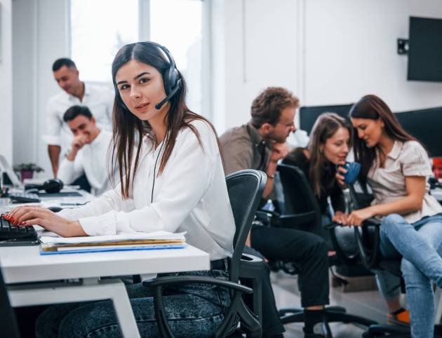 Inside of call center. Young business people working together in the modern office